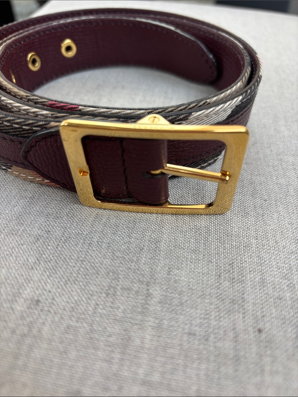 Burberry Burgundy Leather Belt with Gold Buckle and Signature Check Trim.